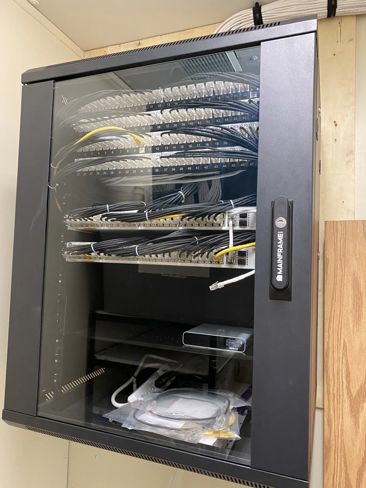 Glass-front network cabinet with cabling and switches